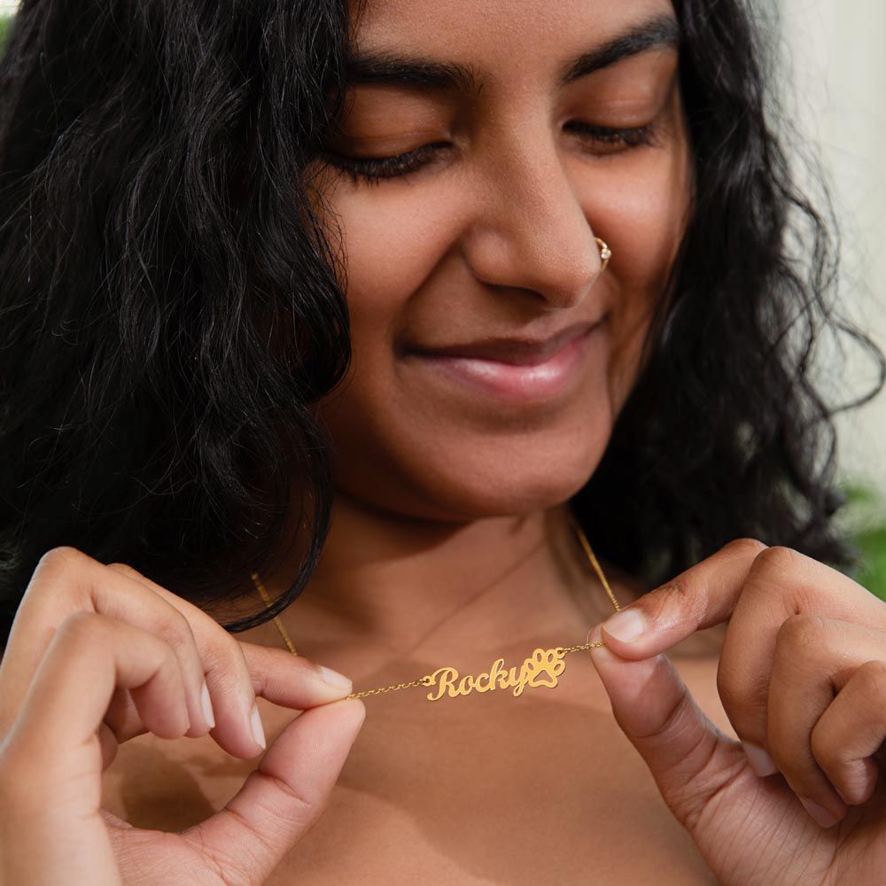 woman wearing personalized paw print name necklace gold color